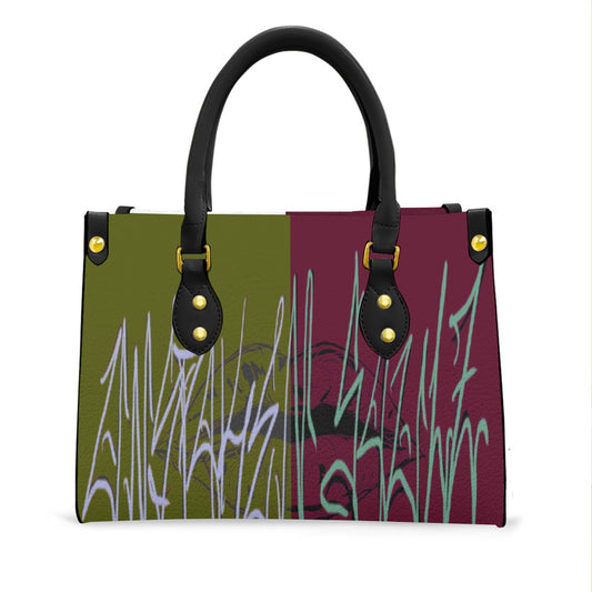 A split color block handbag with a graffiti graphic print in shades of seafoam green, lavender purple, deep maroon, and white, featuring graffiti text and an abstract torn lip background design.